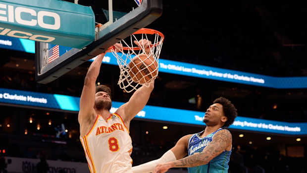 Jan 23, 2022; Charlotte, North Carolina, USA; Atlanta Hawks forward Danilo Gallinari (8) dunks as he is defended by Charlotte Hornets forward PJ Washington (25) during the first half at The Spectrum Center.